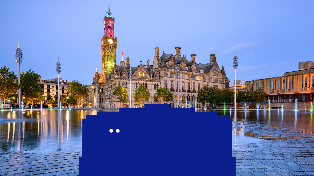 A big blue character looks over to the left, the city of Bradford is in the background.