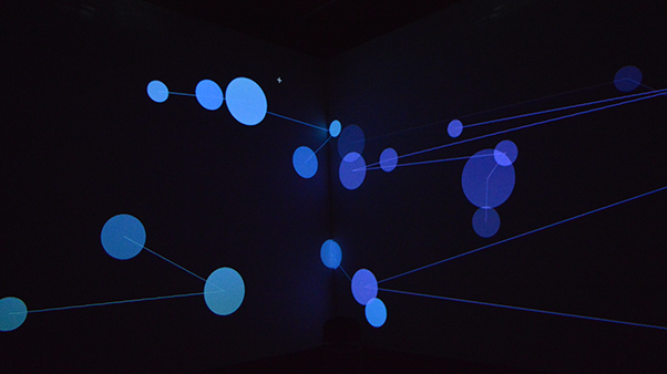 Blue circles of varying sizes are connected by thin lines on a dark background, creating a network-like pattern. The scene is modern and technological.