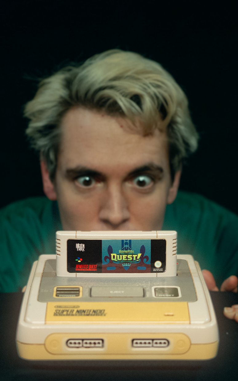 A person with blonde hair is intently staring at a vintage Super Nintendo console with a game cartridge inserted, conveying excitement and nostalgia.