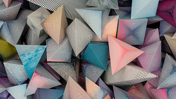 A dense array of colorful 3D pyramids in pastel hues of pink, blue, and grey, with intricate line patterns, creates a dynamic, artistic texture.